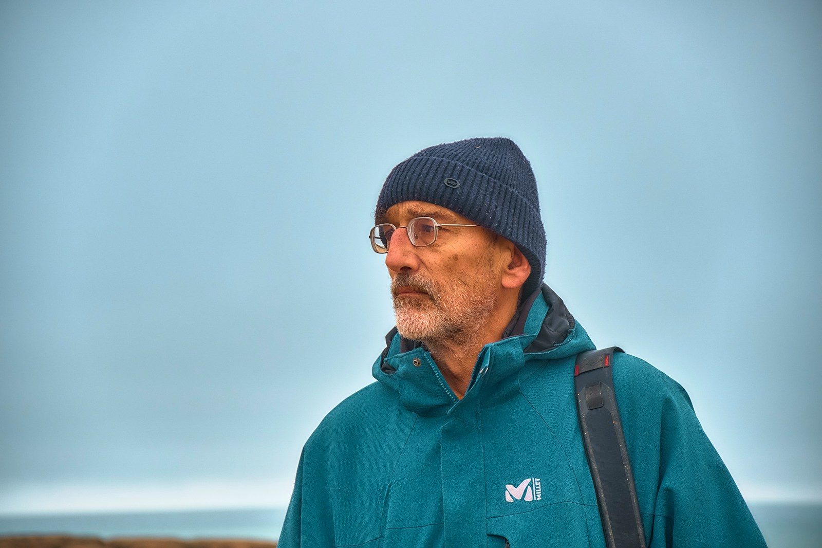 Photo by Kwami Fattah Al Sissi Man wearing a beanie and jacket looking away.
